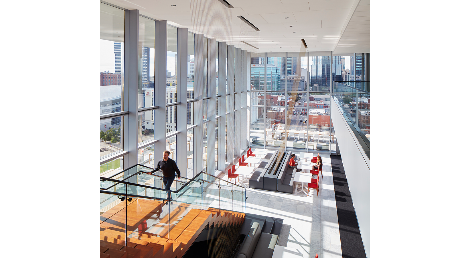 a man walking on a glass staircase in a building