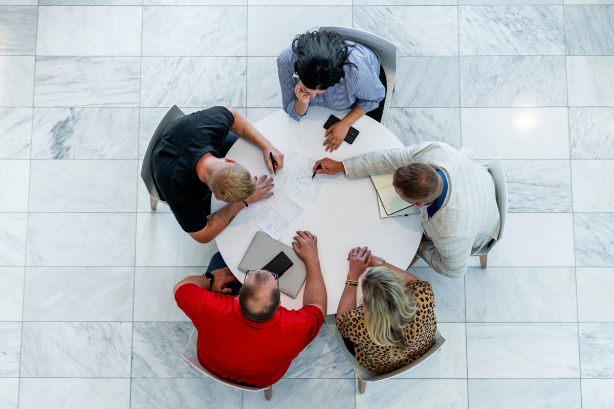 a group of people sitting around a table