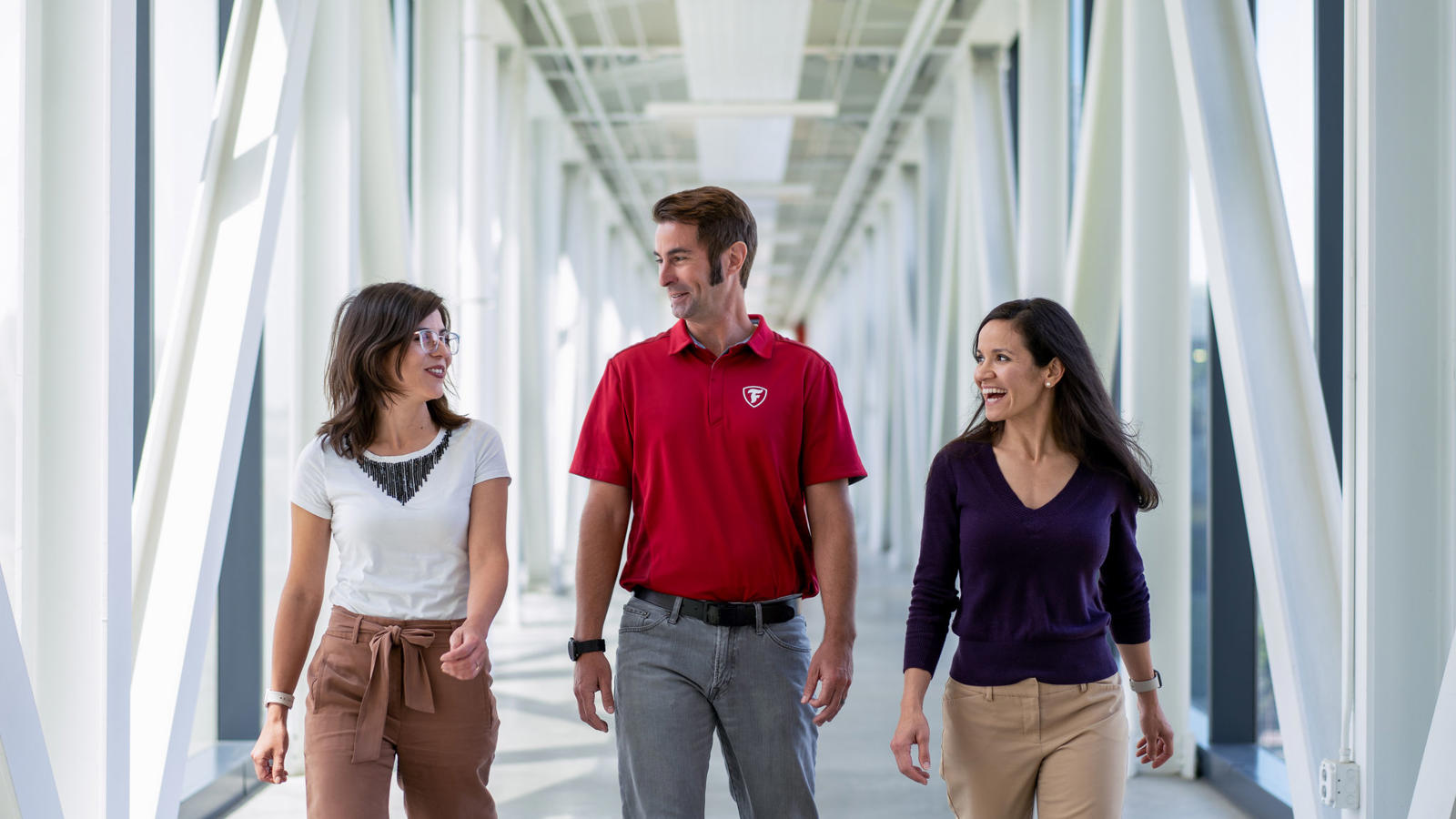 a group of people walking in a hallway