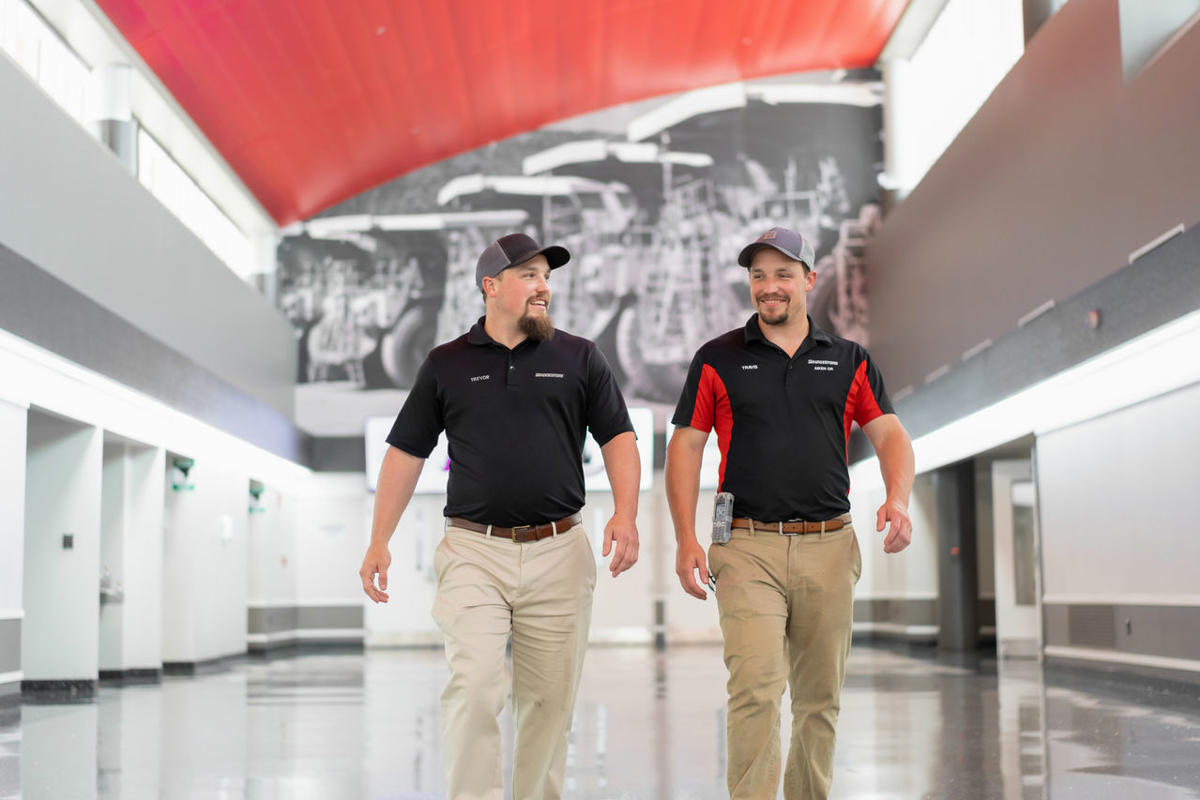 two men walking in a hallway